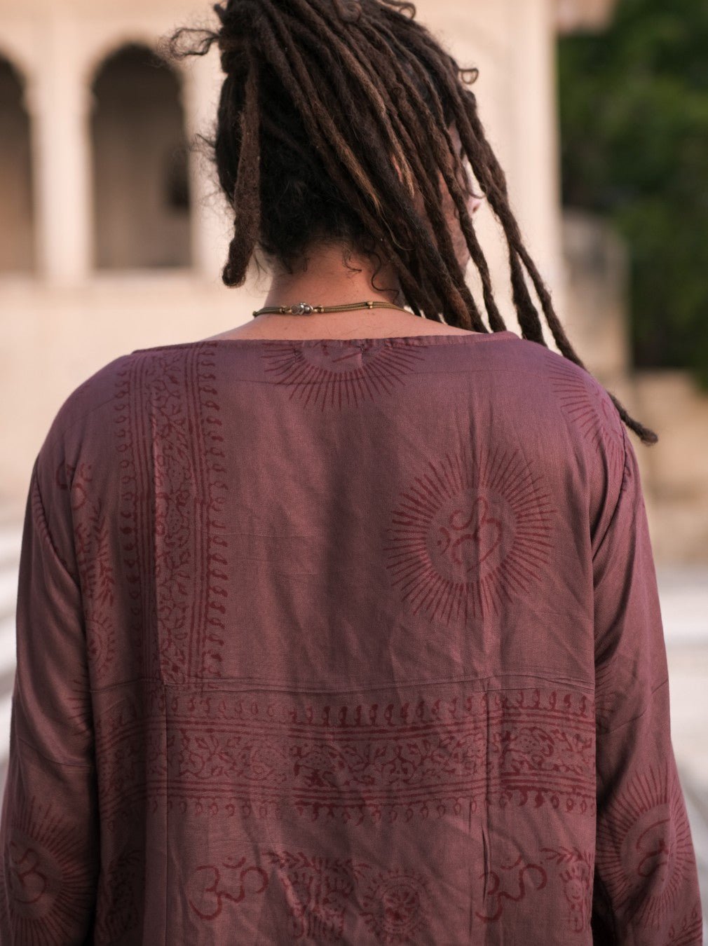 Maroon Om print kurta from behind, medallions and printed border band across the back panel