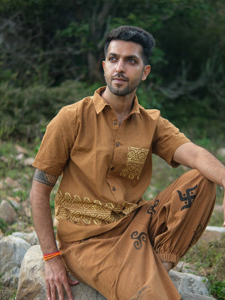 Mustard yellow tribal handblock cotton shirt, seated with print visible