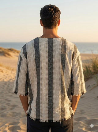 Nakul T-Shirt back view of the unisex striped cotton tee with a raw fringed hem on a sunset beach