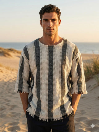 Nakul T-Shirt unisex natural cotton tee with bold black vertical stripes, wide sleeves and a fringed hem worn on a beach