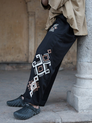 Black Naqsh wide-leg cotton trousers, close side detail of the ivory and copper geometric print motif