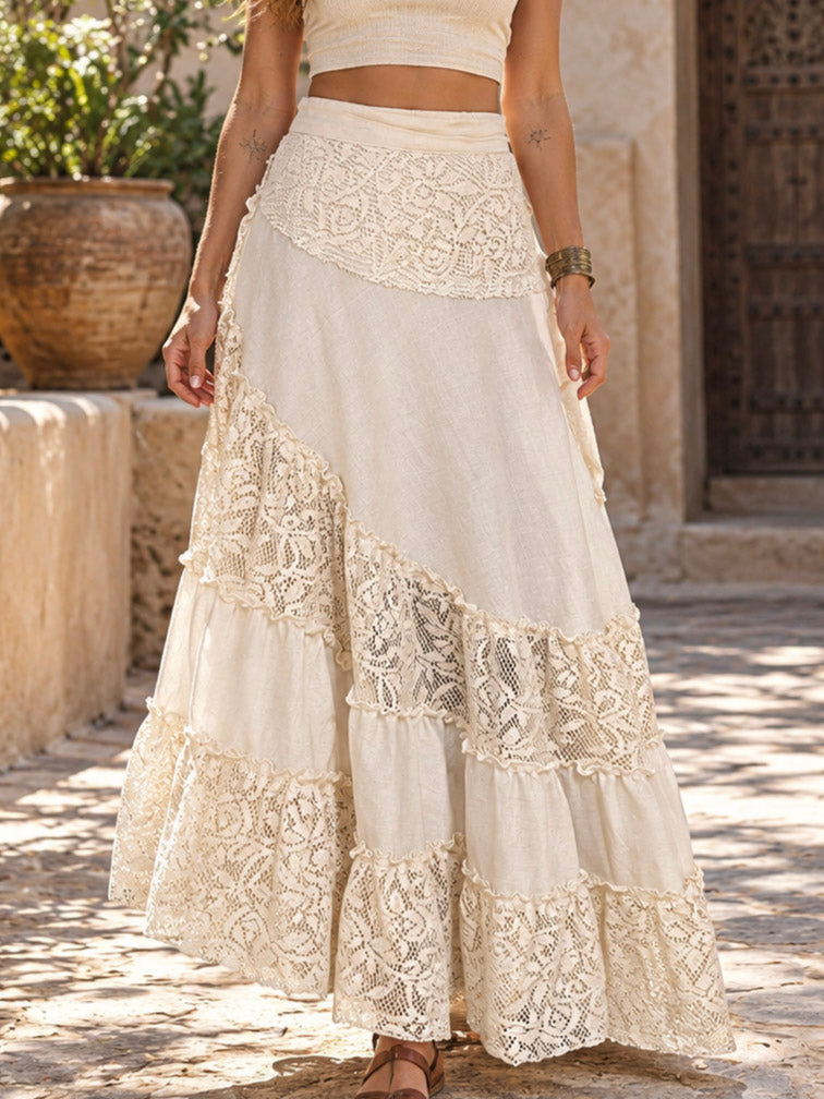 Natural cream gypsy wrap skirt with openwork lace tiers, worn full length on a sunlit tiled courtyard