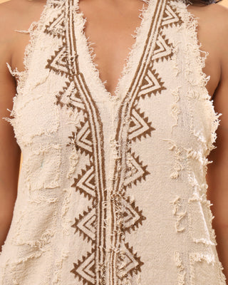 Tribal zigzag embroidery close-up on cream cotton V-neckline
