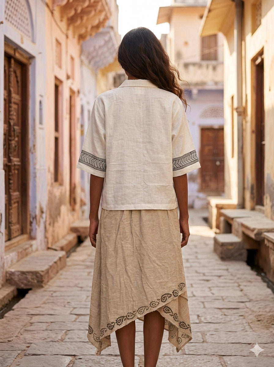 Back view of the Noorrekha Shirt in a sunlit lane showing the printed cuffs and straight hem