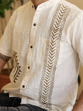 Close-up of off-white cotton-linen shirt with brown arrow stripe and geometric diamond print