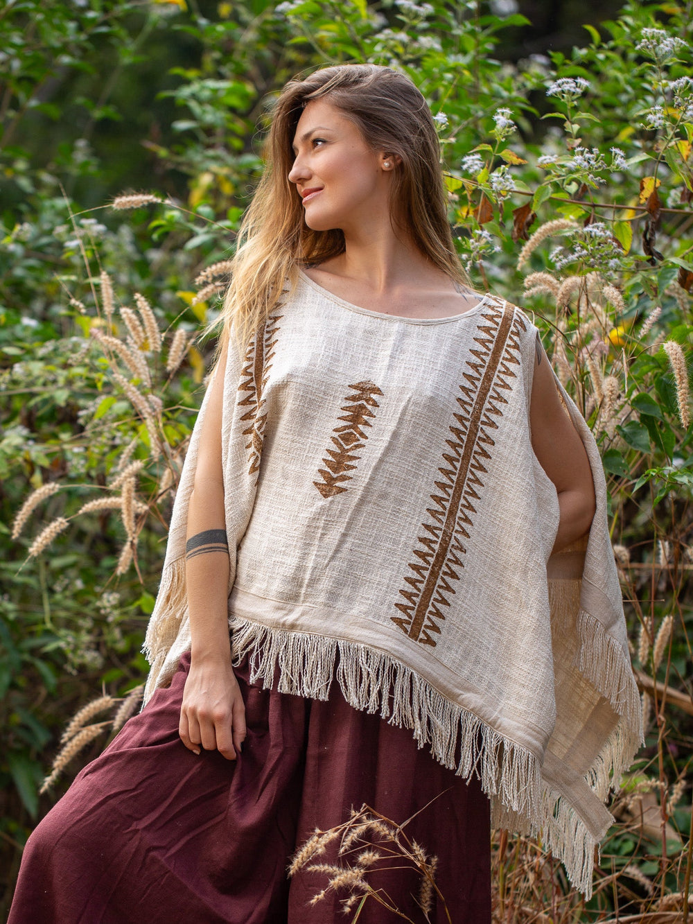 Parvati kimono in natural cream hand block print cotton with brown motifs, model in a green garden