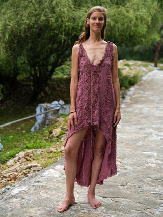 Pink crinkle cotton high-low dress with V-neck, front view on garden path