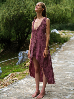 Pink crinkle cotton high-low dress front view in green garden