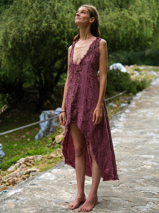 Pink crinkle cotton high-low dress front view in green garden