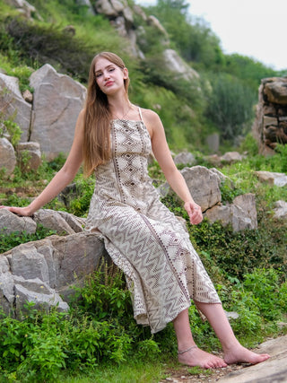 Pomona maxi dress natural print seated in green garden setting