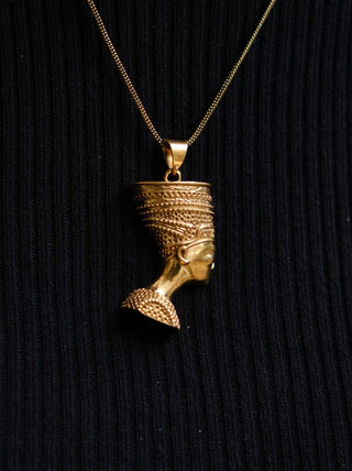 gold color necklace with queen pendant