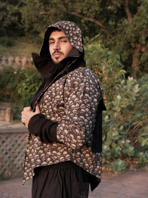 Raaz Jacket three-quarter side view of the black bone-skull print hooded jacket with knit sleeve extension