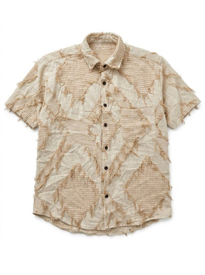 Flat lay of the Raqs beige distressed patchwork short-sleeve cotton shirt