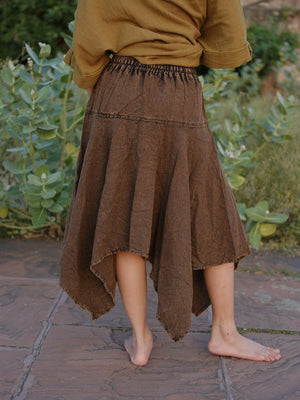 Rati Skirt brown khadi handkerchief hem in soft falling points, worn barefoot on stone paving with a cropped top