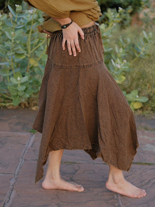 Rati Skirt brown khadi gathered elasticated waistband close up, model's hand resting at the hip, cropped top above