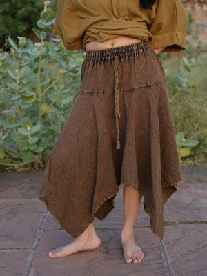 Rati Skirt in brown khadi cotton with the handkerchief hem hanging in long points, styled with a cropped olive top