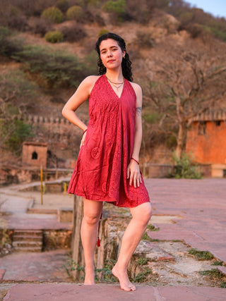Close-up of deep red halter dress with tone-on-tone Om mandala embossed print