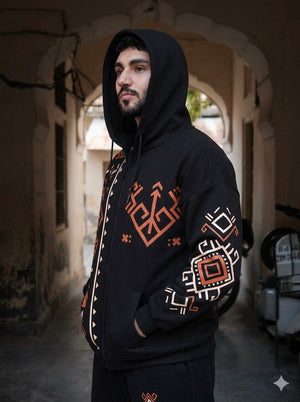 Riwaayat black geometric print zip-up cotton fleece hoodie on a male model, hood up, side view