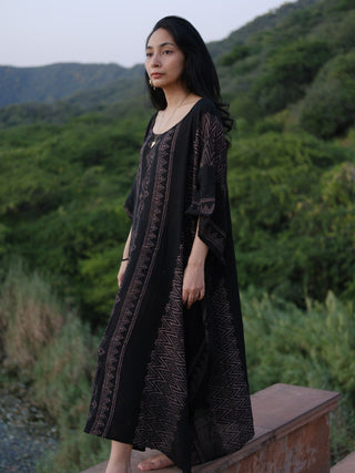 Three-quarter view of the Rooh Kaftan, mauve geometric panels falling to ankle length