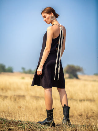 Back view of the Rope Dress showing the low open back and knotted cotton rope shoulder ties on model