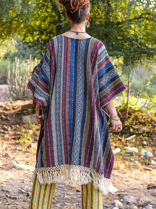 Back view of the Saisha jacquard kaftan showing deep navy stripe panels and the fringe hem