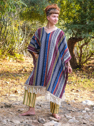 Saisha kaftan worn as a full boho look with striped trousers, shot outdoors in natural light
