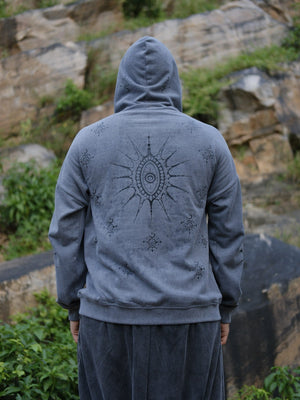 Back of the grey Shaam Hoodie showing the large sun eye graphic and scattered celestial motifs