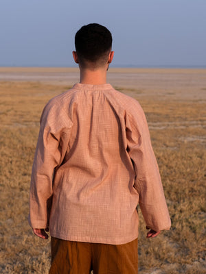 Back view of the Shlok Kurta in beige cotton, showing the gathered yoke and loose unisex fit.