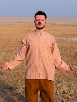 Shlok Kurta in beige cotton, loose unisex fit, worn with arms spread in a calm, boho pose.