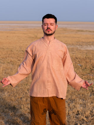 Shlok Kurta in beige cotton, loose unisex fit, worn with arms spread in a calm, boho pose.