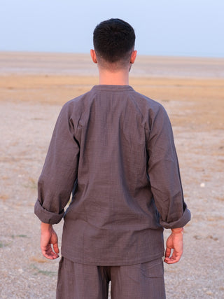 Back view of the Shlok Kurta in grey cotton, sleeves rolled, loose unisex silhouette.