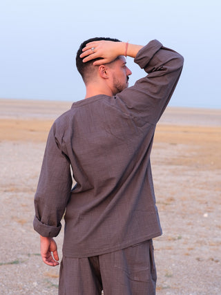 Back view of the Shlok Kurta in grey cotton, one hand resting on the head, relaxed boho fit.