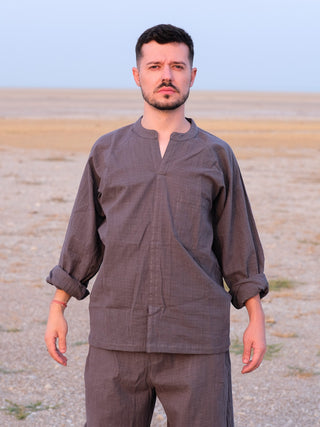 Man in the grey Shlok Kurta with sleeves rolled, relaxed cotton fit, facing the camera.