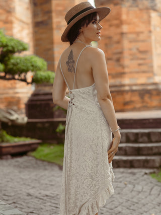Back view of the Surekha white lace dress, showing the cross-back straps and tassel tie
