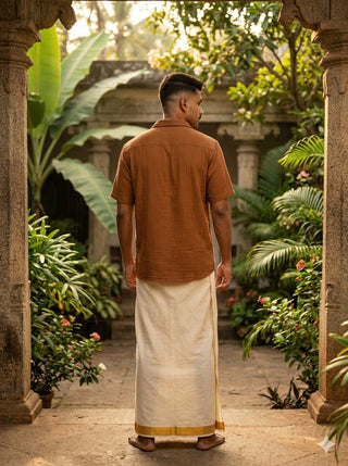 Back view of the Tanay Shirt in camel brown textured cotton, relaxed fit with a curved hem