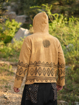 Sand yellow hand block print hoodie with hood pulled up, black geometric print