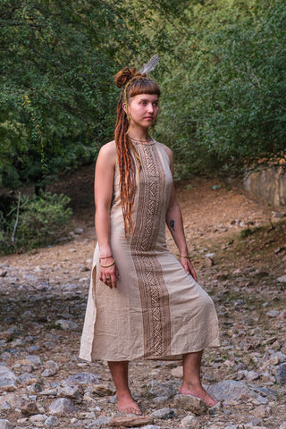 Trishika hand block print khadi cotton maxi dress in natural beige worn on a rocky forest riverbank