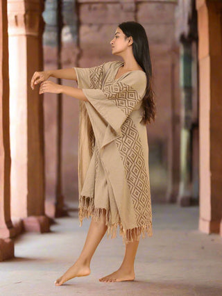 Beige block print kaftan in flowing dance pose at heritage stone corridor, free-size cotton dress
