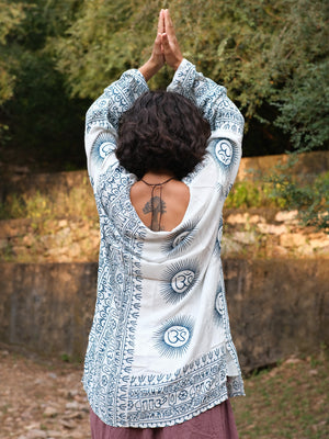 Back view of the white blue Om print kurta with arms raised, printed medallions across the back