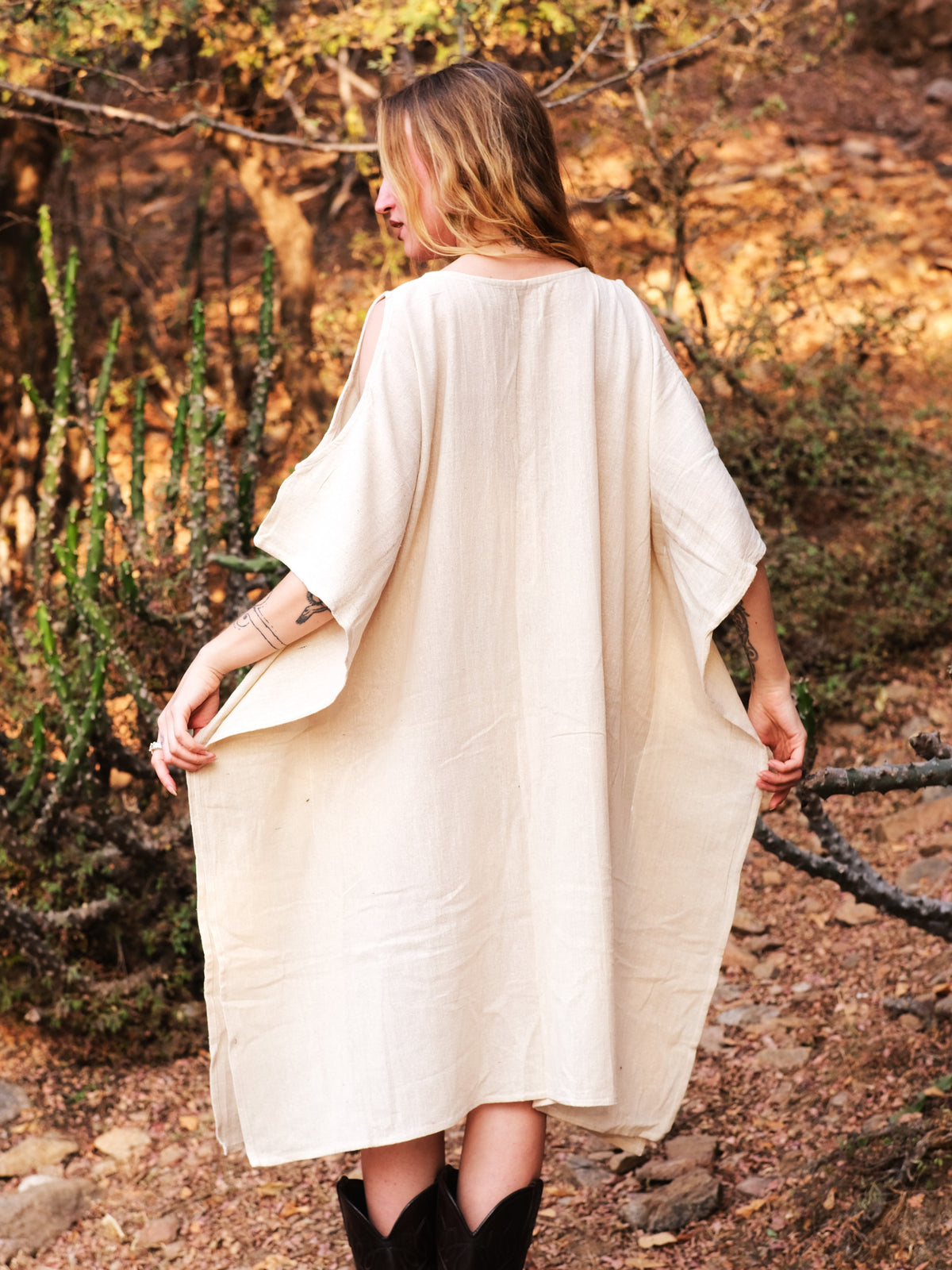 Back view of the Yaja Kaftan showing the round neck, open back panel and wide batwing sleeves
