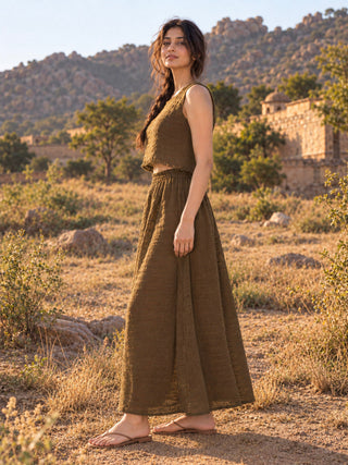 Brown long cotton Zarra skirt in a three-quarter stance, showing the gathered elasticated waistband and flared hem